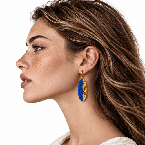 On-model profile view of Blue Tide in Golden Trace gold and cobalt blue ceramic dangle earring showing scale
