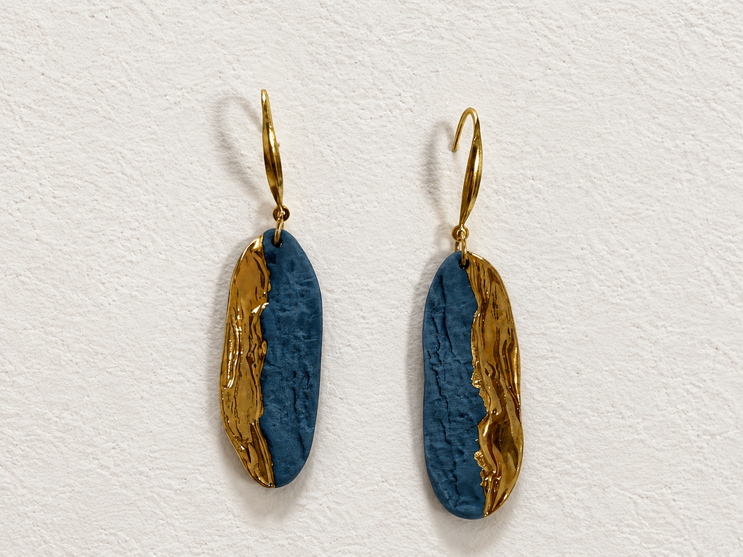 Blue Tide, Golden Trace handmade ceramic earrings showing deep blue ceramic texture and an organic gold-plated edge by ZELIN ART.