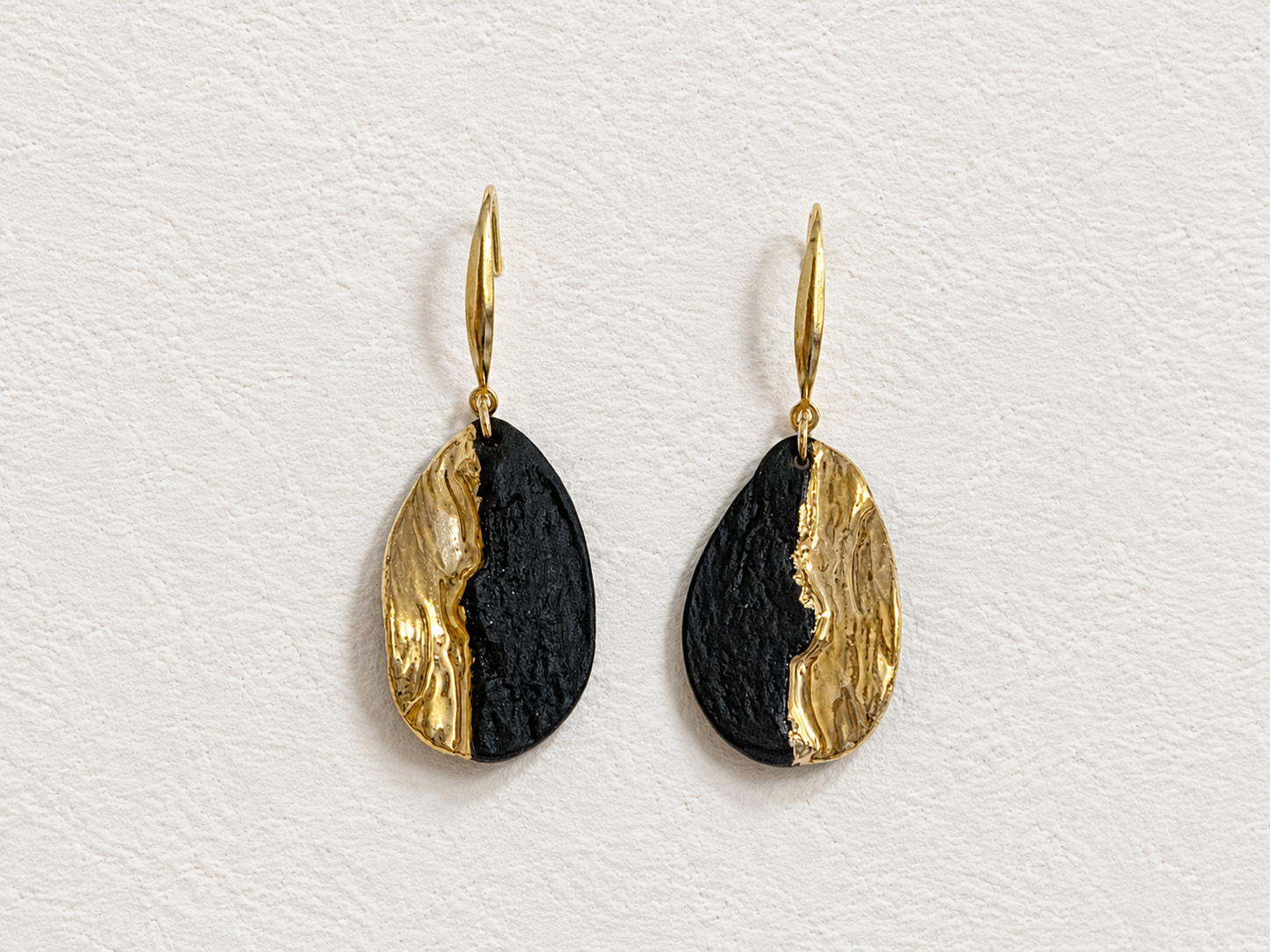 Obsidian Shore handmade ceramic earrings showing a dark porcelain surface and warm gold-plated detail by ZELIN ART.