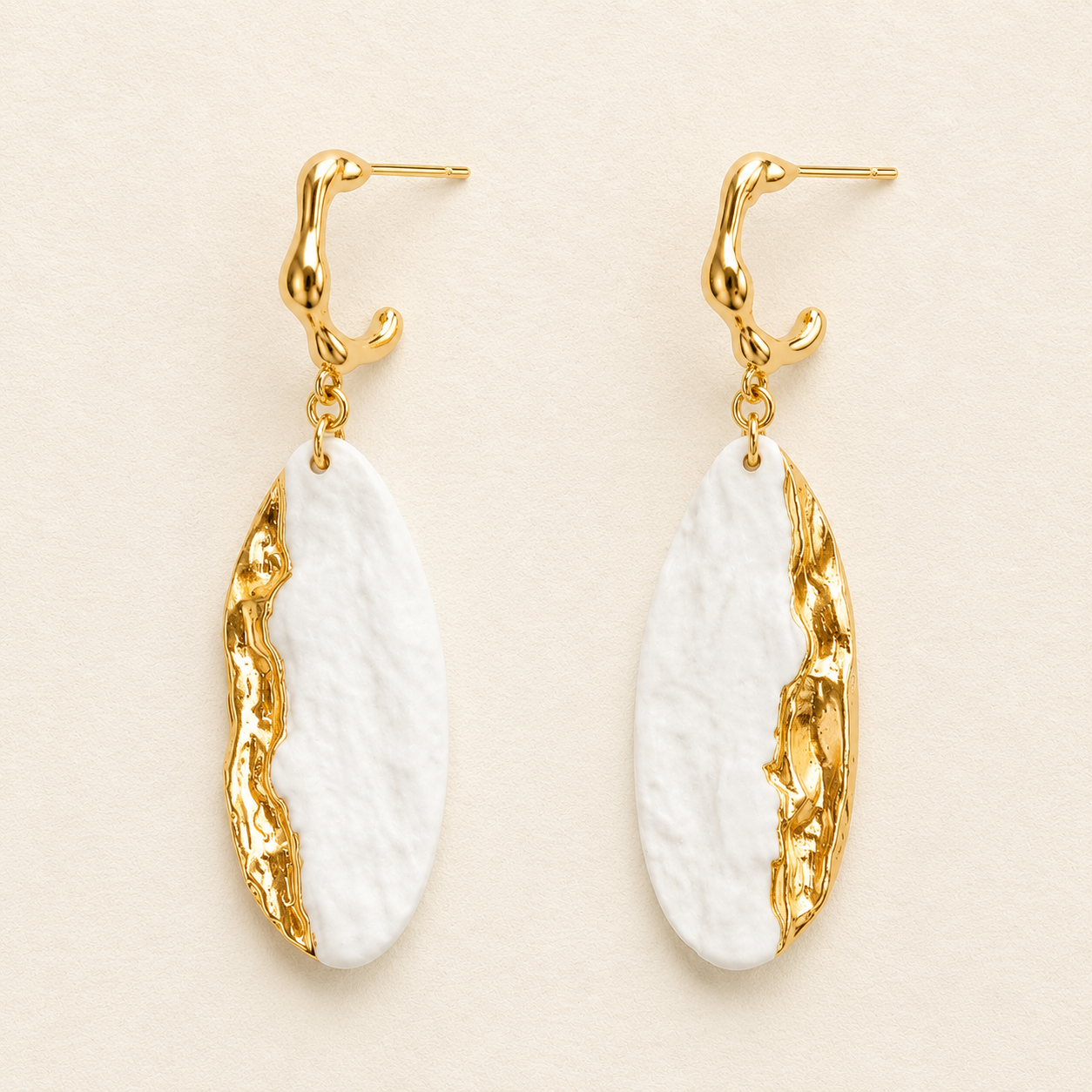 Ivory Current handmade ceramic earrings showing ivory ceramic texture and a flowing gold-plated edge by ZELIN ART.