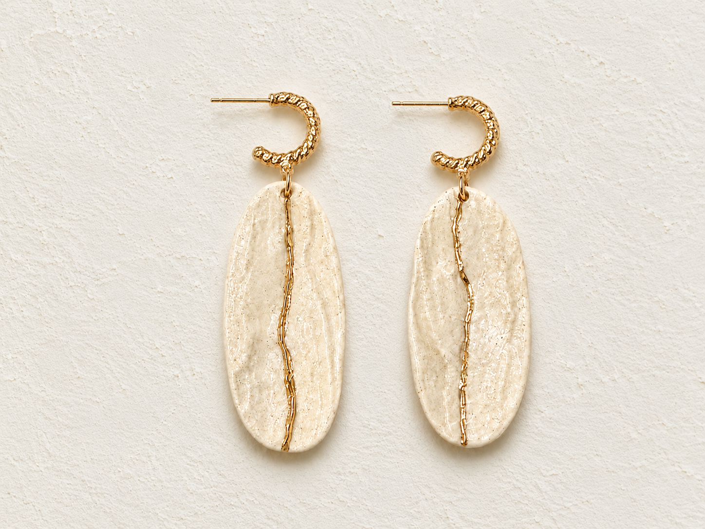 Light of Dawn handmade ceramic earrings showing a soft white ceramic surface and gold-plated silver posts by ZELIN ART.