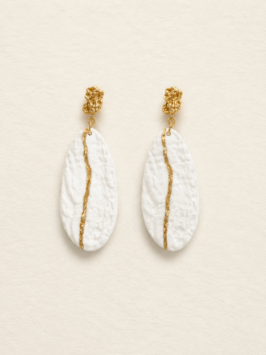 Isle of Warm Light handmade ceramic earrings showing warm white ceramic texture and gold-plated detail by ZELIN ART.