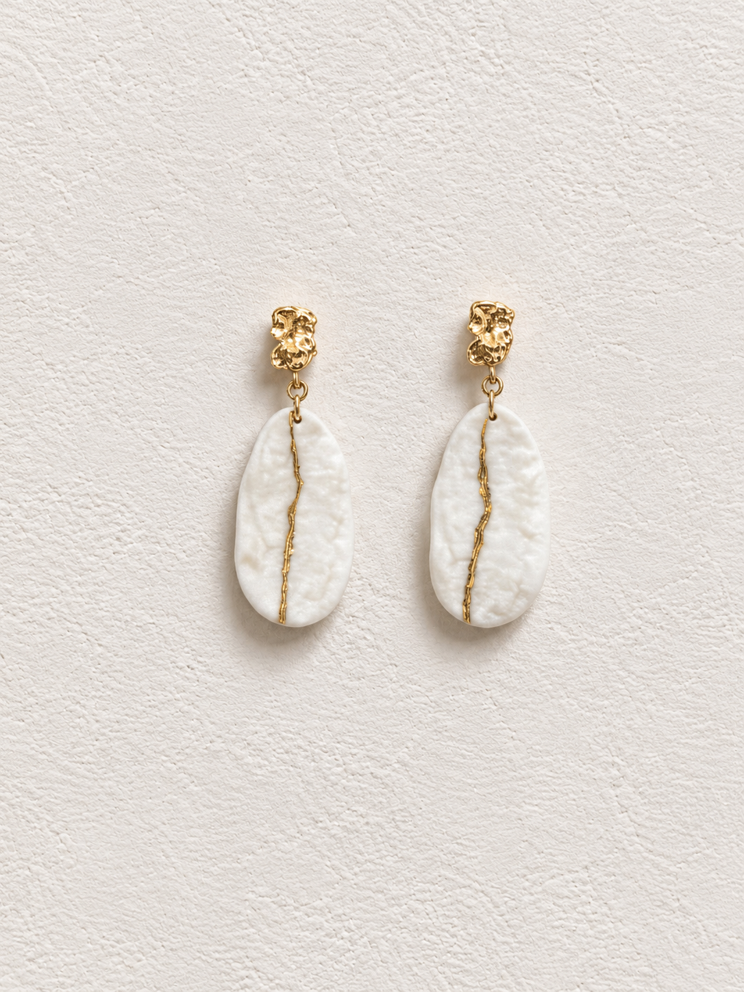 Isle of Warm Light handmade ceramic earrings showing warm white ceramic texture and gold-plated detail by ZELIN ART.