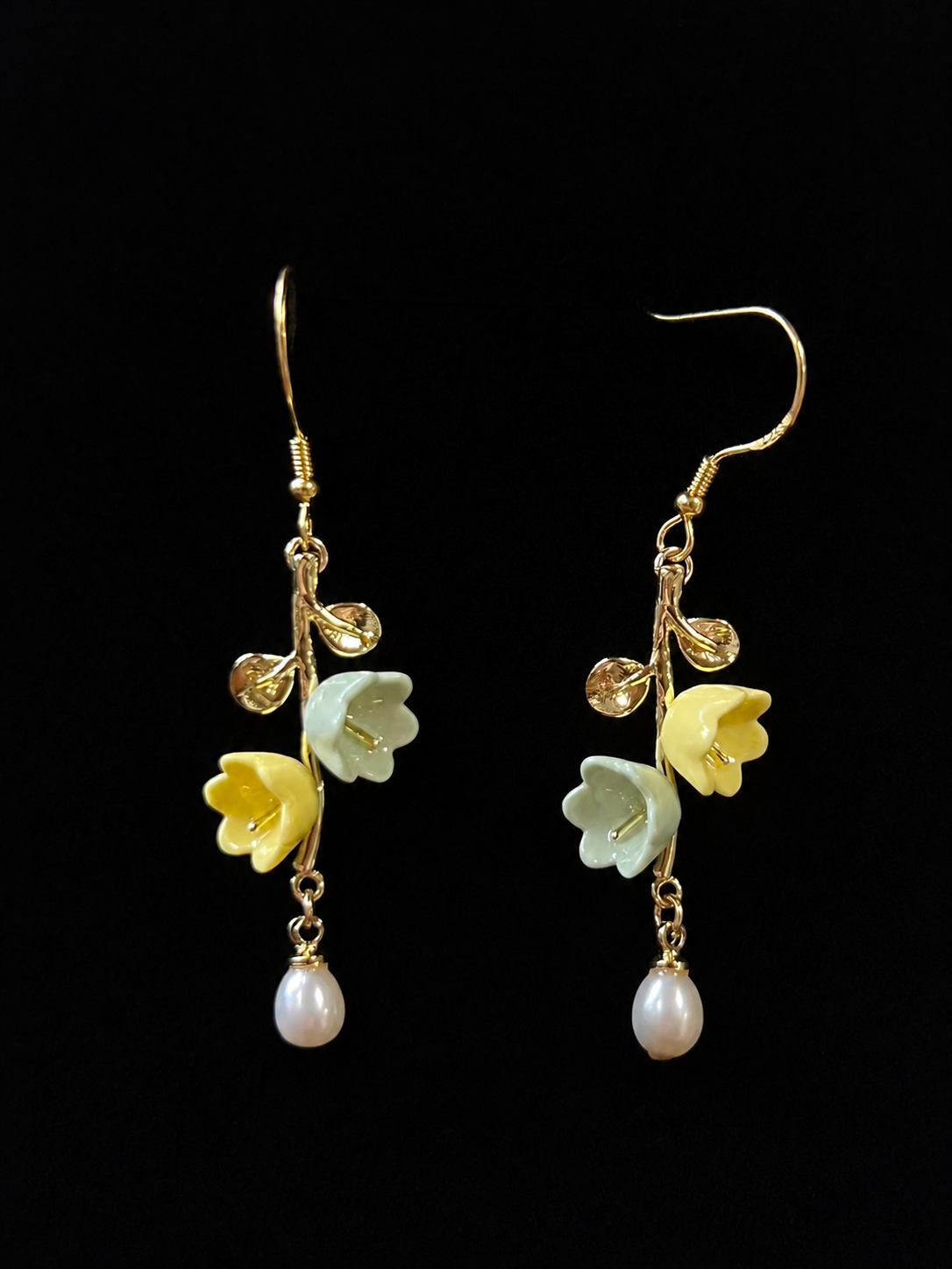 Petal Rhythm handmade porcelain earrings showing layered white ceramic petals and gold-plated detail by ZELIN ART.