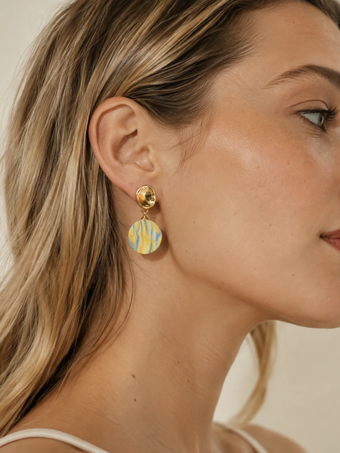 TERRA porcelain earrings styled with layered yellow, blue, and gold color.