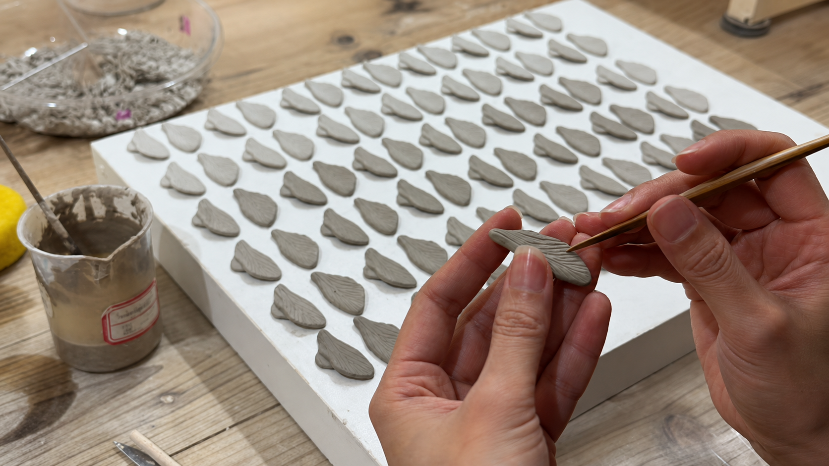 Hand carving the ceramic surface of a ZELIN ART porcelain jewelry form.