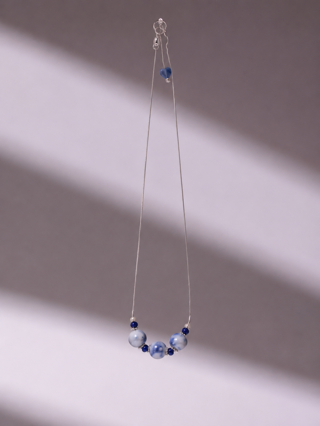 Blue porcelain necklace product still life