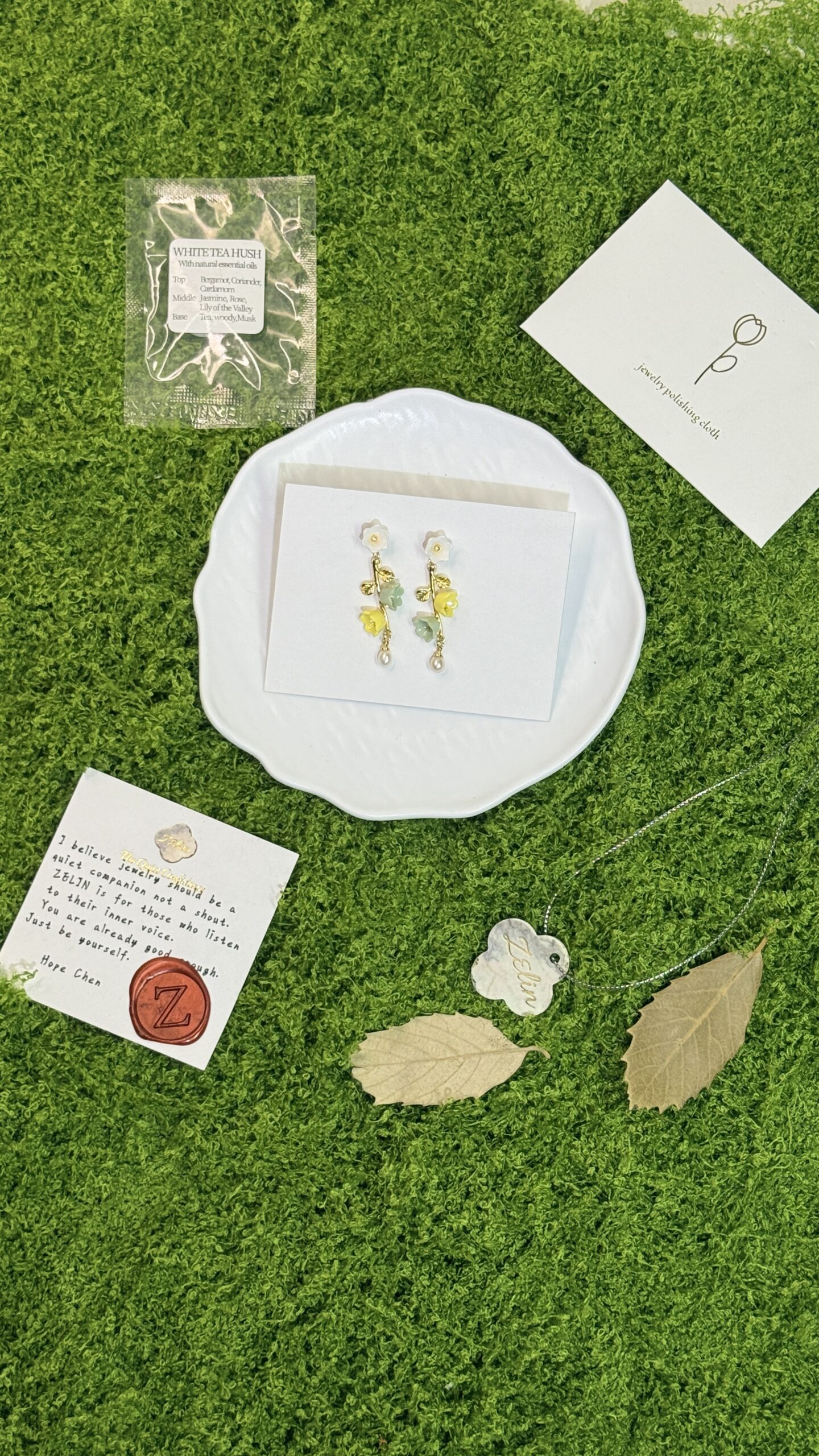 Layered gift-ready packaging, care card, and presentation details for ZELIN ART porcelain jewelry.