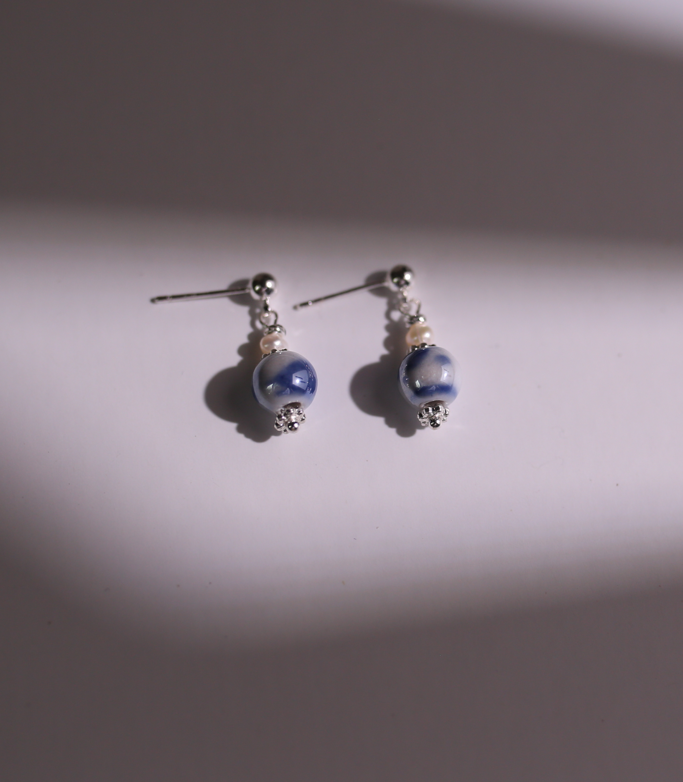 Blue porcelain earrings product still life